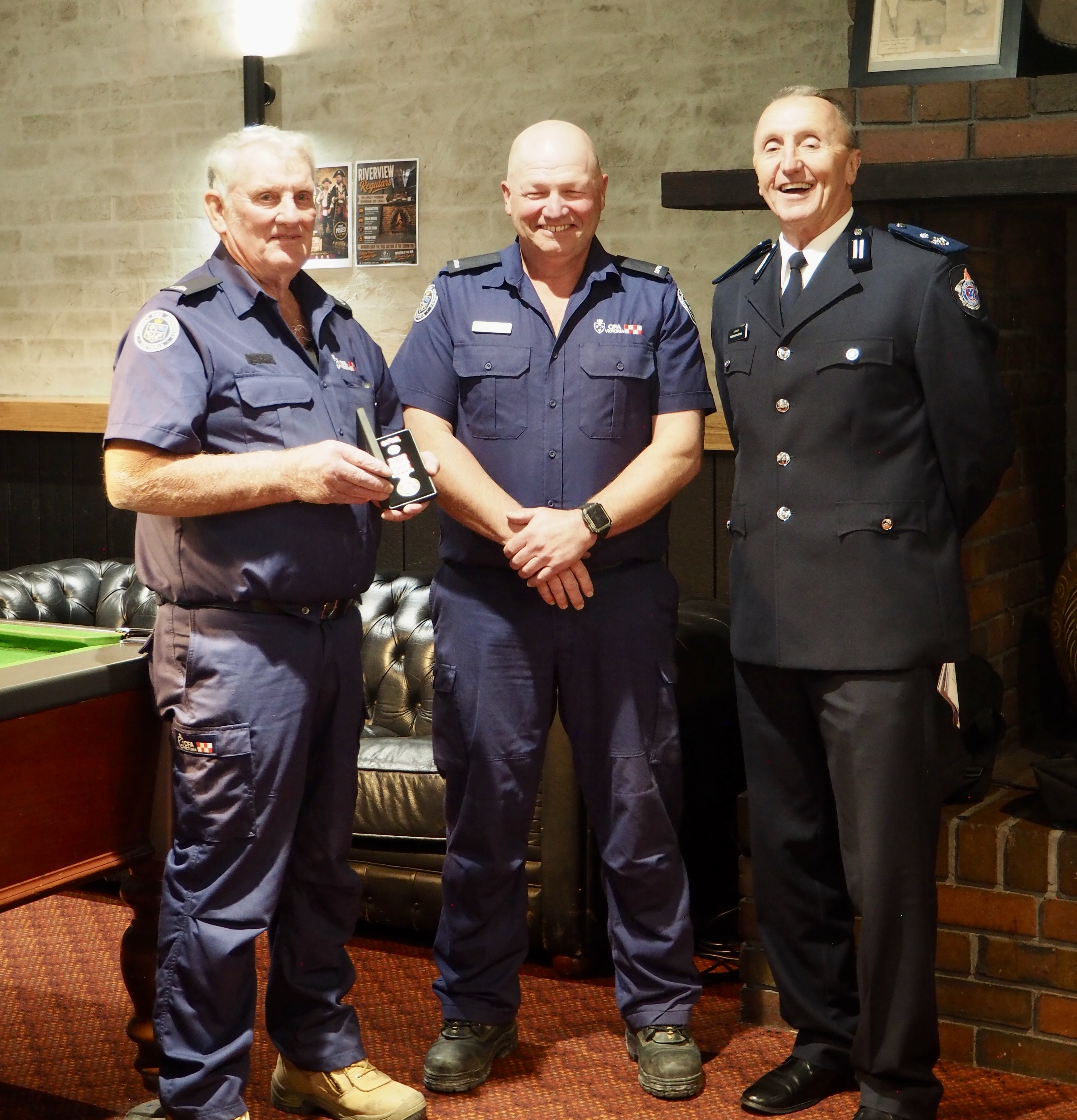 Ken Harris is presented his 55-year CFA Life Member medal by Pound Creek Captain Mick Hughes and District 9 Commander Andrew McCartney.
